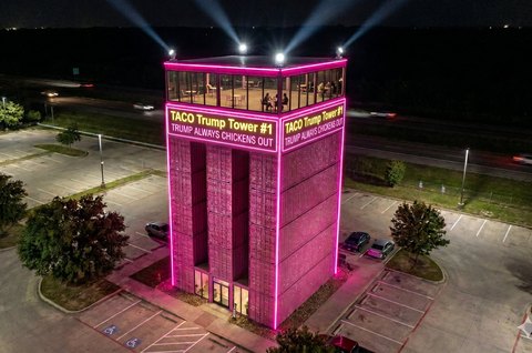 TACO Trump Tower at night — Sissy Hot Pink glowing on the highway